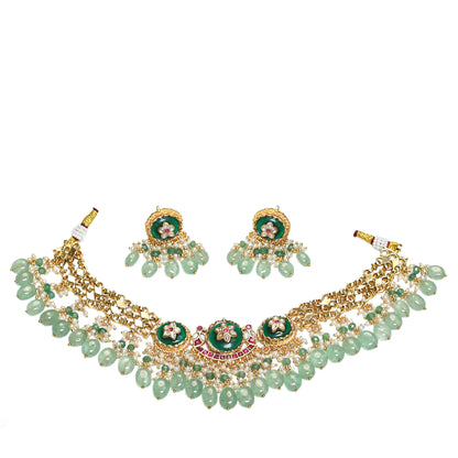 Gold necklace with green beads and gemstones on a white background